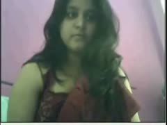 On a webcam, a lovely and plump Indian girl removes her saree.